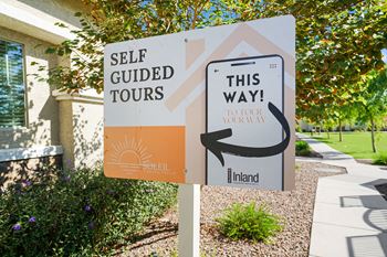 A sign that reads self guided tours in front of a building